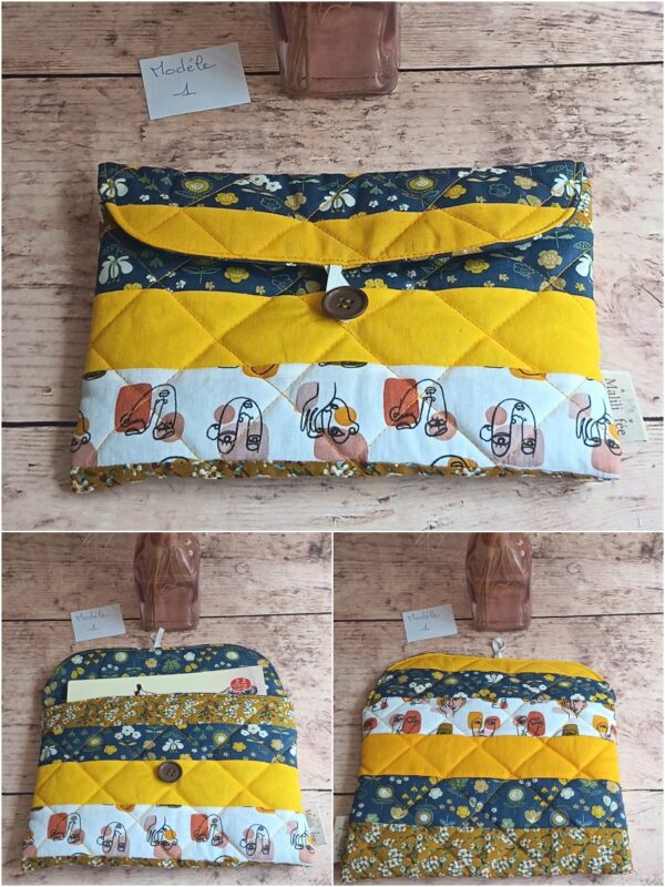 Pochette à livre de poche en tissu Modèle 1 à motifs visages artistiques, fleurs bleues et bande jaune moutarde.