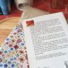 Gros roman posé à côté de la pochette grand livre tissu Rozenn Prune montrant la qualité de la doublure